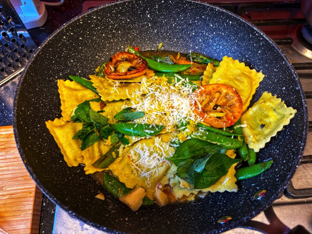 Pea Asparagus Ravioli Garnished with basil, nuts, parmesan and seared lemon slices